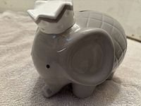Front angle showing the large gray ceramic elephant with crown, highlighting ear and body detail.