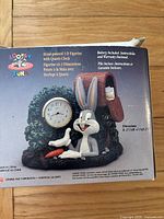 Box back showing hand-painted 3D Bugs Bunny figurine with quartz clock image and product details