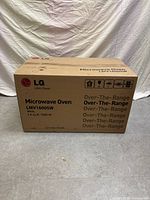 Sealed cardboard box with LG logo and model details.
