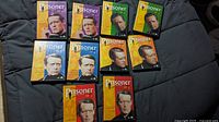Top-down view of nine DVD volumes of The Prisoner laid out with front cover art showing actor Patrick McGoohan and colorful backgrounds.