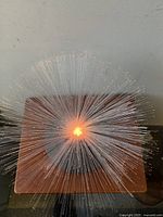Top view of vintage fibre-optic lamp showing radiating fiber optic strands lit from center