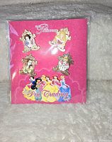 Front view of the collectible Disney princess pin set on pink card featuring six enamel pins.
