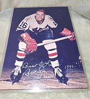 Full view of signed Bobby Hull 8x10 Chicago Blackhawks hockey photo, showing player in uniform, skating pose, and signature dated 1992.