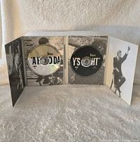 Fold-out DVD case with two discs and black and white photos of The Beatles inside.