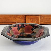 Front-angle view showing octagonal shape and interior pomegranate decoration