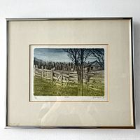 Framed coloured etching showing a farm scene with wooden fences, gate, and barn, plus leafless trees.