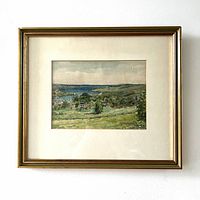 Full view of the framed watercolour painting showing the scenic landscape with trees, water, houses, and sky