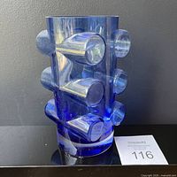 Front view of vase showing cylindrical body and applied knobs