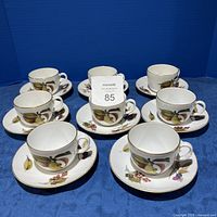 Photo showing all 8 cups and 8 saucers with the fruit design and gold trim on each piece.