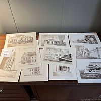 Top view of the 10 prints spread on a table showing black and white sketches of buildings and landmarks.