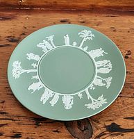 Top view of the green Wedgwood Jasperware plate showing the classical white relief figures encircling the plate.