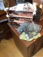 Vintage carved wooden 3-drawer corner case with intricate cut-out designs shown on an angled surface.