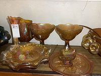 Full display showing large water pitcher, decorative vase, pair of pedestal fruit bowls, plate bowl, and candy dish arranged on wooden surface.