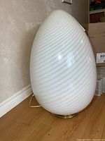 Front-side view of the egg-shaped lamp showing overall form and spiral ribbing.
