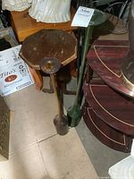 Both stretched glass bottles shown side by side on floor near furniture and other decorative items