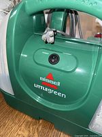 Close-up of Bissell Little Green cleaner power switch and logo
