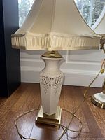 Full view of Lenox porcelain lamp with shade on wood floor