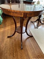 Full profile of the round table showing pedestal base and splayed legs
