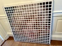 Full frontal view of the square acrylic framed ceramic chip artwork showing the grid layout.