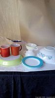 Photo of all items together showing various plates, mugs, teacups, and the Cinderella bowl.