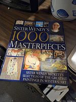 Cover of 'Sister Wendy's 1000 Masterpieces' showing title and collage of western art paintings.