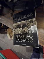 Single photo of Migrations book by Sebastião Salgado showing front cover with photography theme