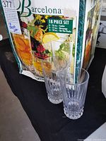 Box and two glass samples from the set showing vertical cut glass pattern and clear glass material.