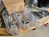 Photo showing three identical clear plastic shower storage units with suction cups on a table.