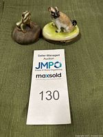 Both figurines together on a green cloth.