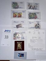 Collection of various US Mint stamps in clear protective packaging with pricing and identification labels.