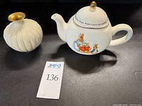 Beatrix Potter ceramic teapot with plastic floral insert and Lenox porcelain vase with gold trim