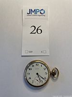 Front view of the vintage Waltham Fogleman pocket watch showing the white dial with black numerals, minute and hour hands, and a small seconds subdial.