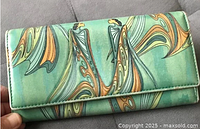 Front of Maxine Noel "Friends" wallet showing painted abstract figures on green faux leather with snap front