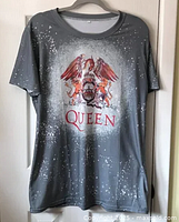 Full front view of the grey Queen T-shirt with white paint splatter and large crest logo on front.