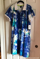 Full view of the U.S. Polo Assn tie dye dress hanging, showing overall pattern and design.
