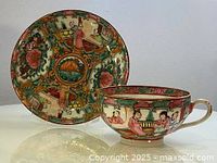 Teacup and saucer side by side showing full artwork and colors on each piece.