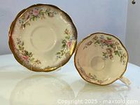 Teacup and saucer viewed from the top showing floral pattern and gold trim.
