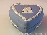 Heart-shaped light blue jasperware box with white classical relief decorations on lid and sides