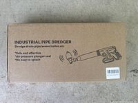 Box of new industrial pipe dredger showing product name and features.