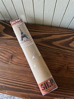 Silpat baking mat rolled in original packaging with Silpat brand and Eiffel Tower graphic visible on label, indicating it is made in France.