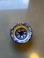 Top view showing the intricate blue floral hand painted design inside the bowl and along the rim.