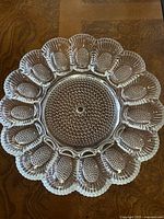 Top view of clear vintage glass deviled egg platter with hobnail and bubble pattern