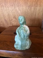 Front view of the vintage jade abstract human figure sculpture showing seated posture and polished surface.
