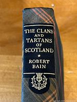 Spine of the book showing the title, author Robert Bain, and a thistle emblem with tartan-patterned background.
