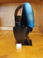 Side angle view of black Ecofan AirDeco II with curved blade and base showing overall design