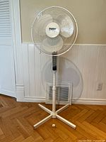 Full view of the Haier white stand fan showing the entire stand, base, pole and fan head.