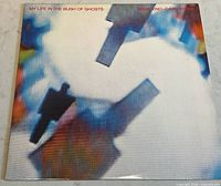 Front cover of the vinyl album showing abstract colorful artwork with shadows resembling microphones and text 'My Life in the Bush of Ghosts' and artist names.