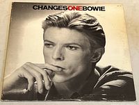 Front cover of vintage vinyl album ChangesOneBowie by David Bowie showing a black and white portrait photo of Bowie with the title in bold text.
