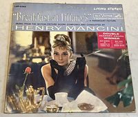 Front cover of 'Breakfast at Tiffany's' vinyl LP showing Audrey Hepburn image, RCA Victor label, Living Stereo branding and award sticker.