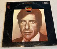 Front cover of the album showing a close-up portrait of Leonard Cohen in sepia tones with black border and album title.